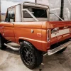 An old Ford Bronco has been turned into a short-wheelbase pickup truck with a powerful engine.