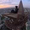 An extreme sportsman climbed the spire of a building on Kotelnicheskaya embankment